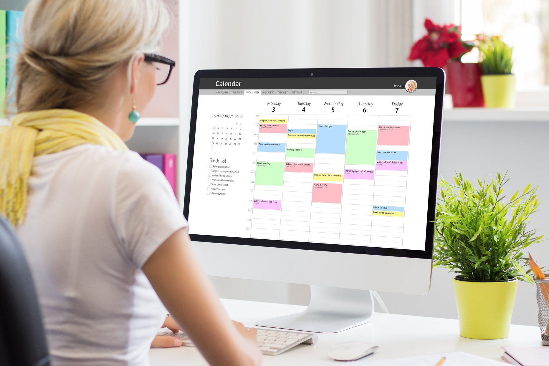 Woman Using Calendar App on Computer in Office